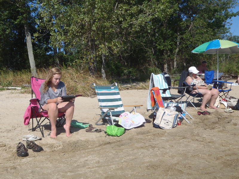 Reading on a sandy beach