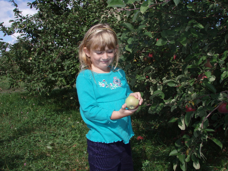 Ella picks an apple